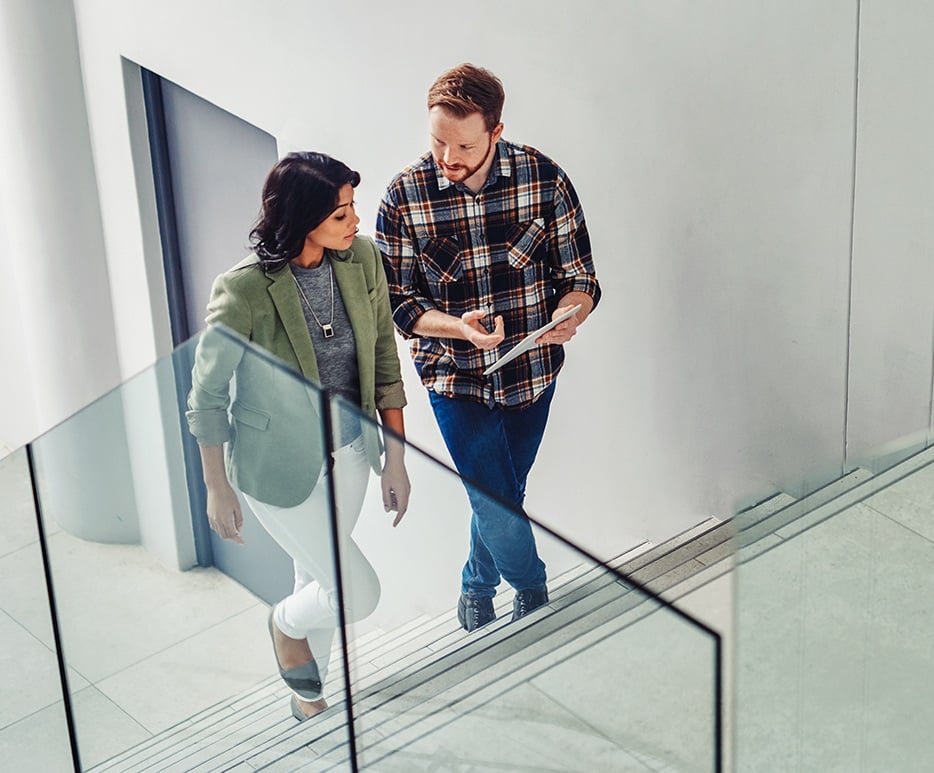 Two people walking up stairs